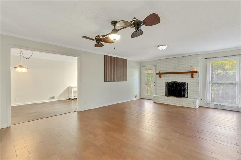 228 Shady Lane Canton, GA 30115 - Photo 7 of 36 an empty room with windows and fireplace