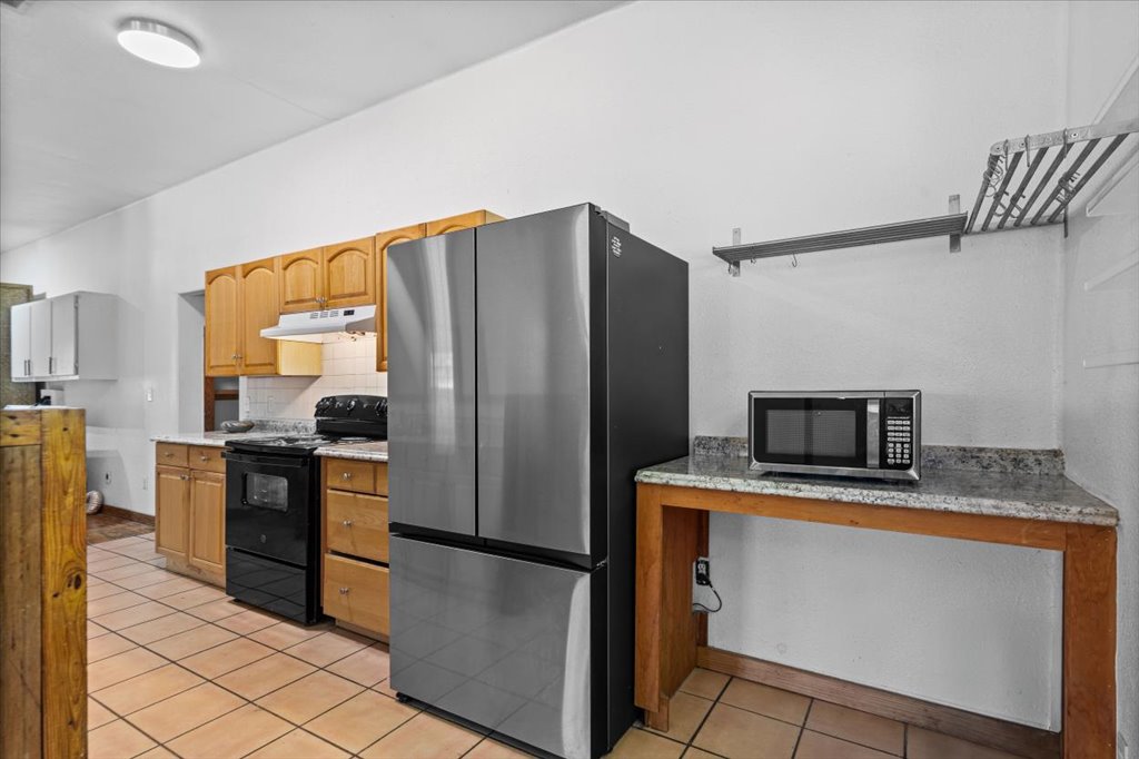 555 Harmon Hills Road, Unit A Dripping Springs, TX 78620 - Photo 14 of 29 Functional kitchen with ample cabinetry and countertop space awaits your culinary creations.