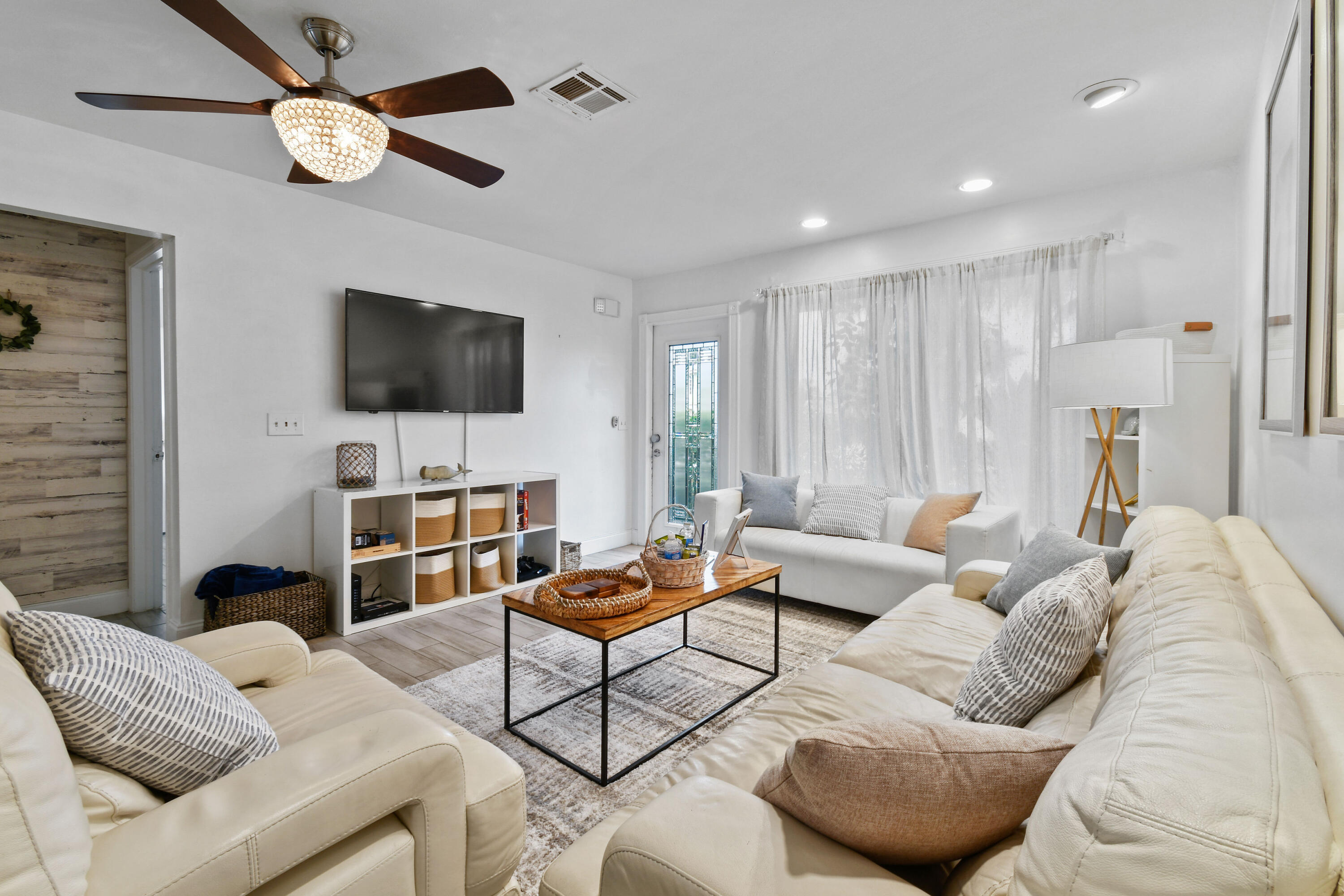 973 Laurel Road North Palm Beach, FL 33408 - Photo 12 of 57 a living room with furniture and a flat screen tv