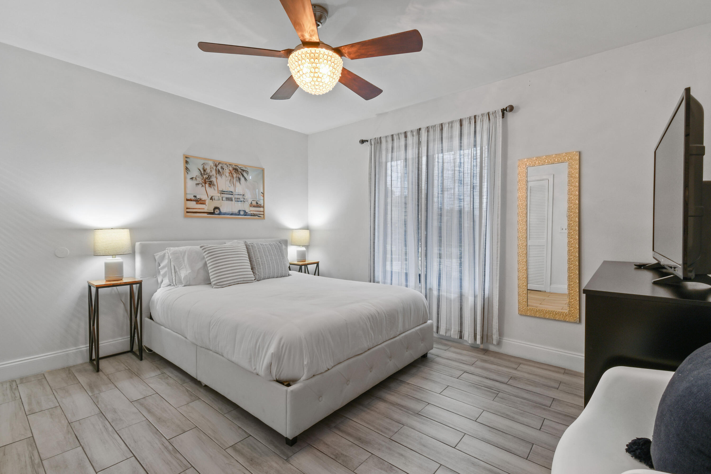 973 Laurel Road North Palm Beach, FL 33408 - Photo 23 of 57 a bedroom with a bed and a chandelier