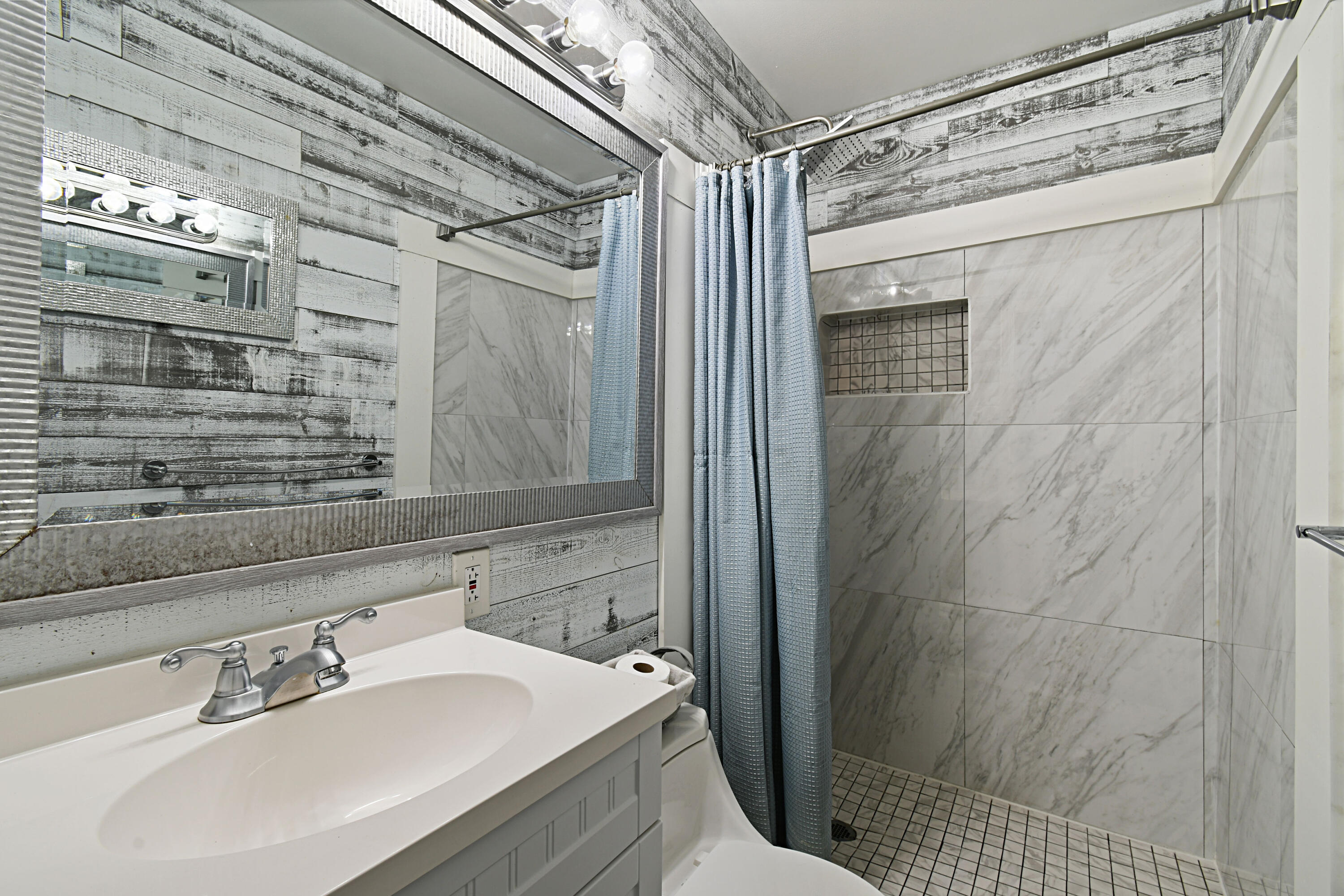 973 Laurel Road North Palm Beach, FL 33408 - Photo 25 of 57 a bathroom with a sink shower and a mirror