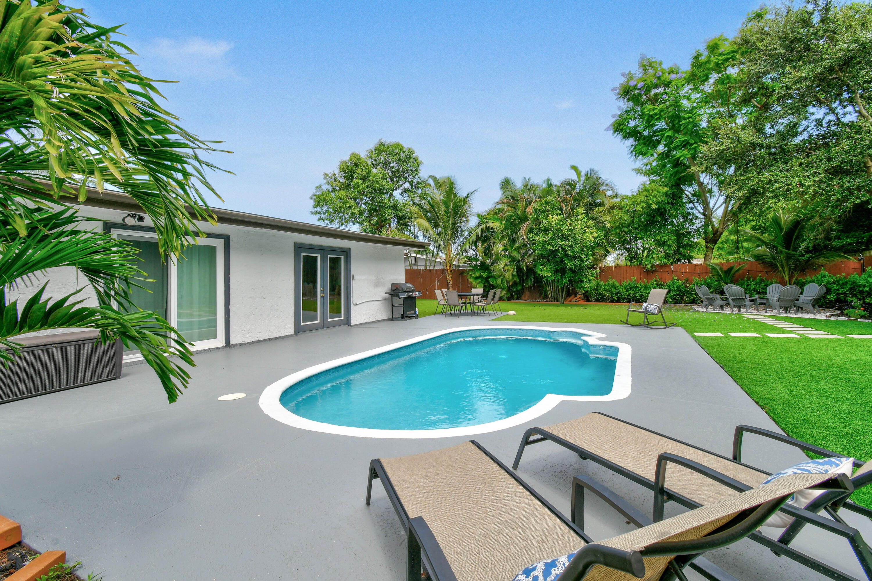 973 Laurel Road North Palm Beach, FL 33408 - Photo 4 of 57 a view of house with swimming pool outdoor seating yard and green space