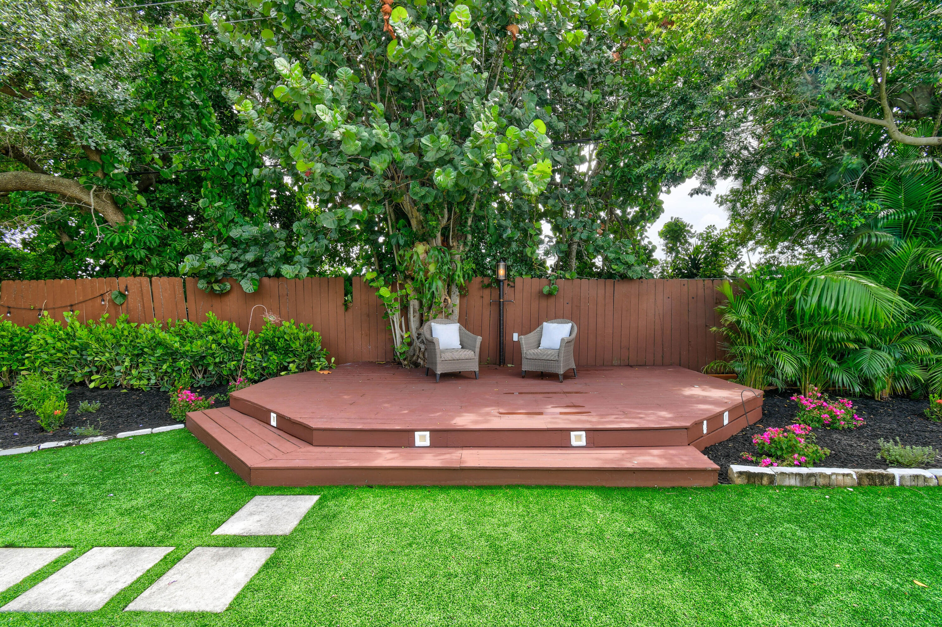 973 Laurel Road North Palm Beach, FL 33408 - Photo 41 of 57 a view of a back yard with a bench
