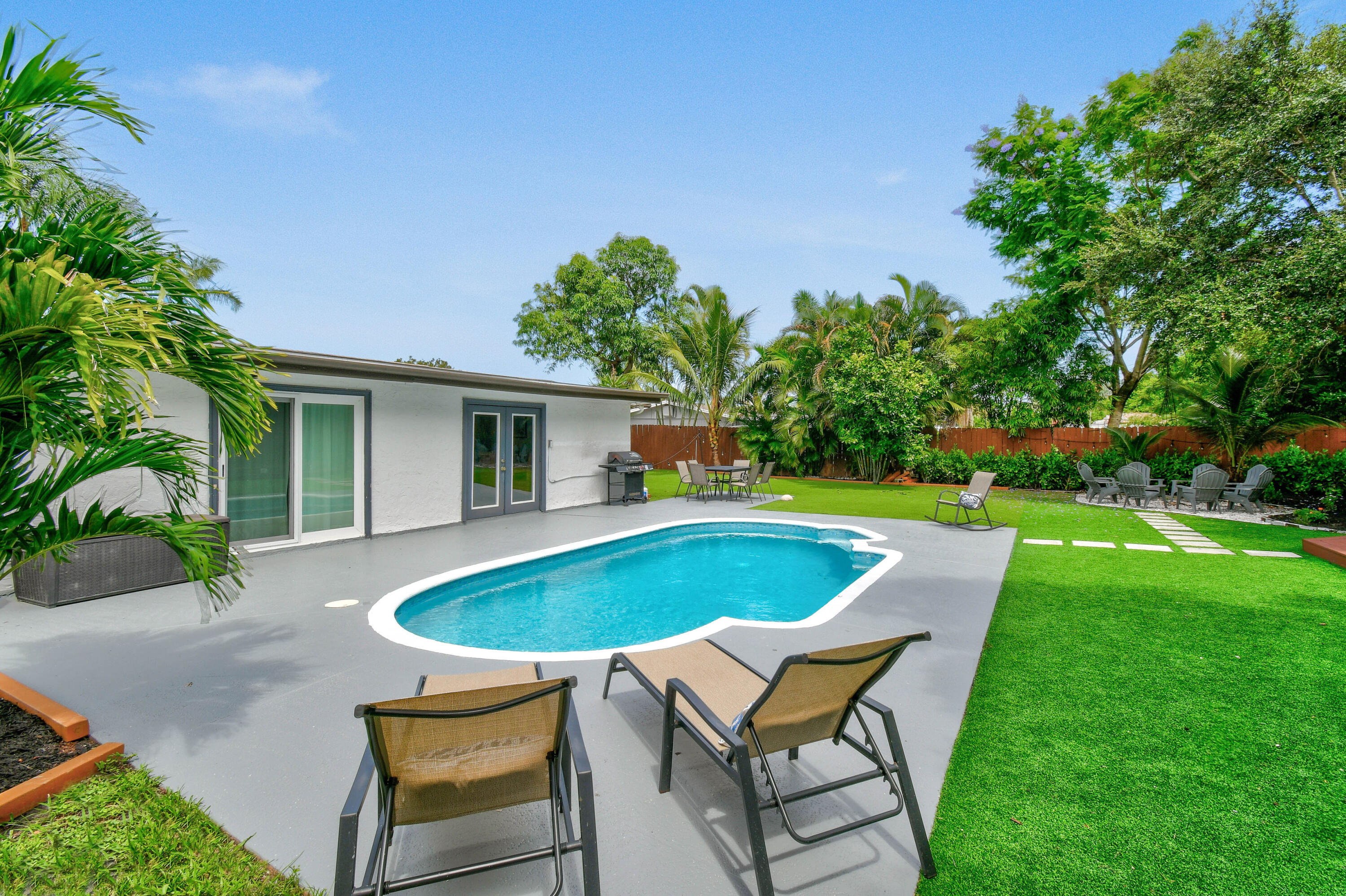 973 Laurel Road North Palm Beach, FL 33408 - Photo 42 of 57 a swimming pool with outdoor seating and yard