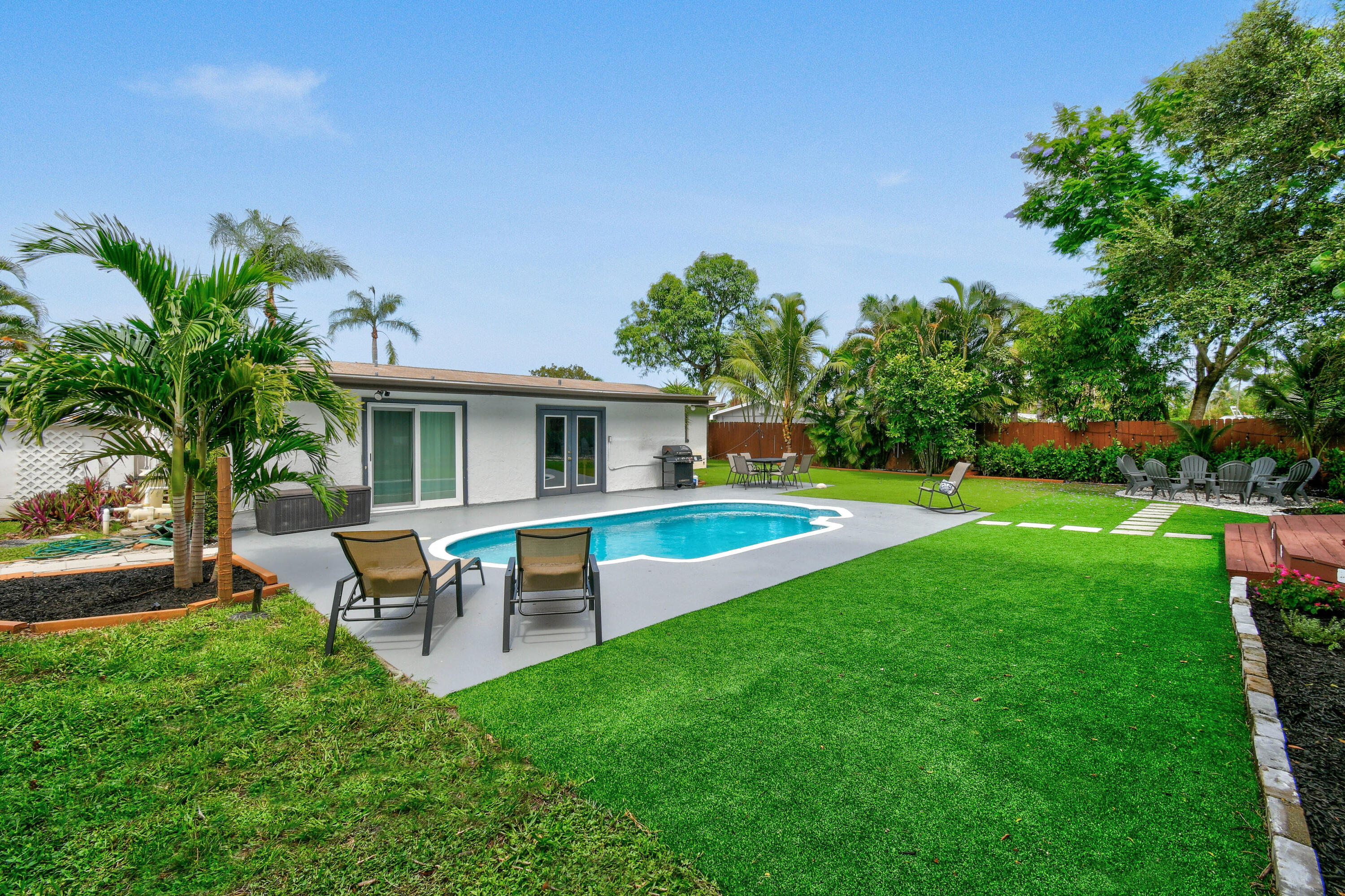 973 Laurel Road North Palm Beach, FL 33408 - Photo 43 of 57 a front view of house with yard and outdoor seating