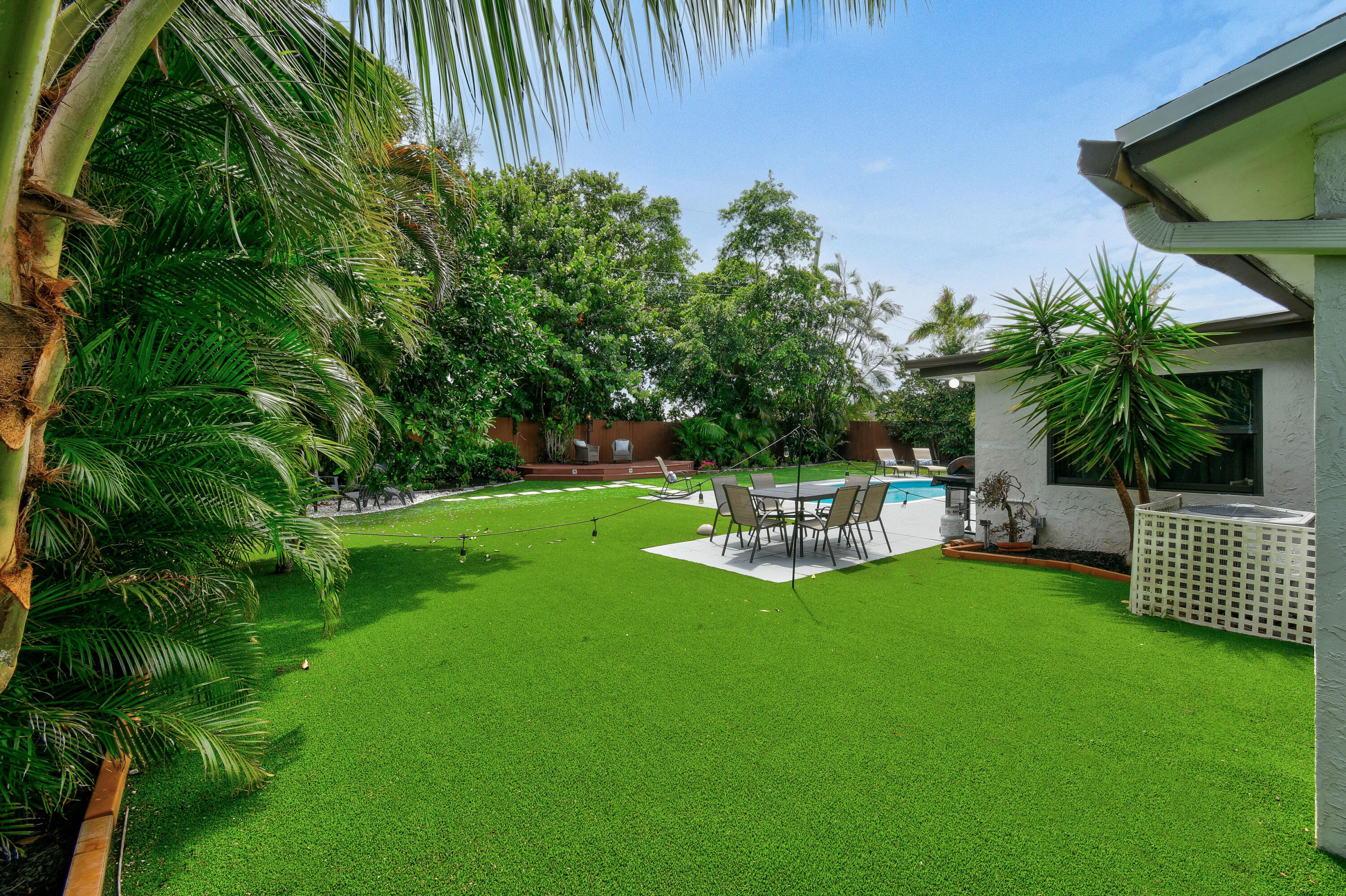 973 Laurel Road North Palm Beach, FL 33408 - Photo 51 of 57 a view of a chair and table and garden with wooden fence