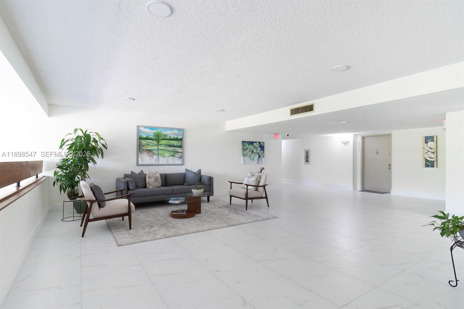 16200 Golf Club Road, Unit 312 Weston, FL 33326 - Photo 14 of 31 a living room with furniture and potted plants