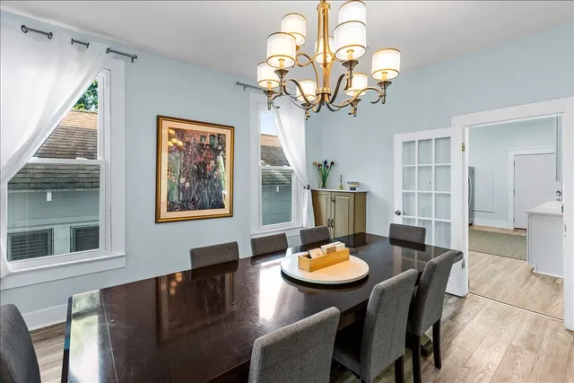 a view of a dining room with furniture wooden floor and chandelier