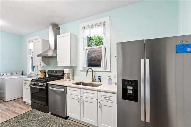 a kitchen with stainless steel appliances a refrigerator sink and stove