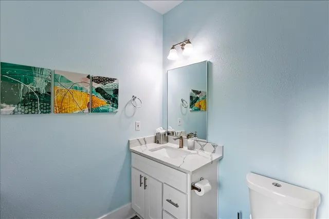 a bathroom with a sink vanity and a mirror