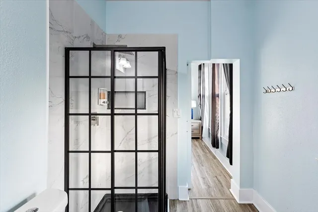 a bedroom with bed and a book shelf