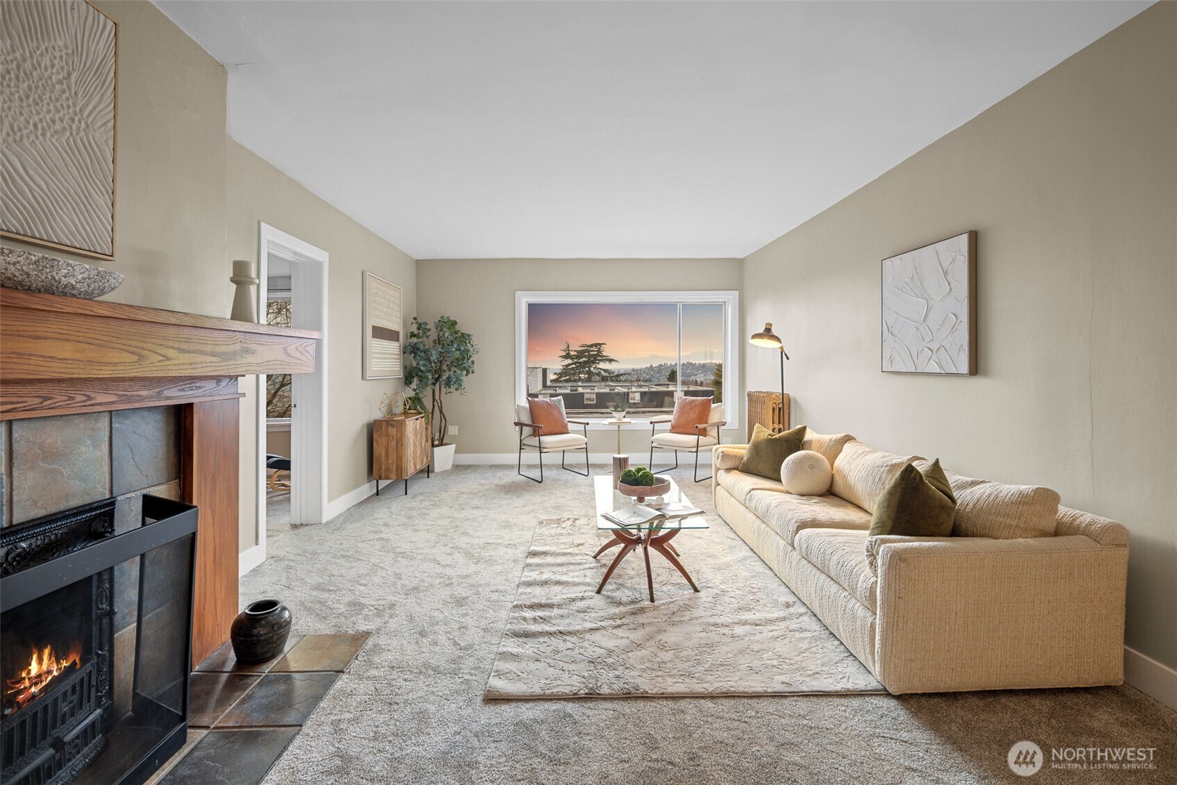 630 13th Avenue East, Unit 3 Seattle, WA 98102 - Photo 4 of 22 a living room with furniture a fireplace and a table