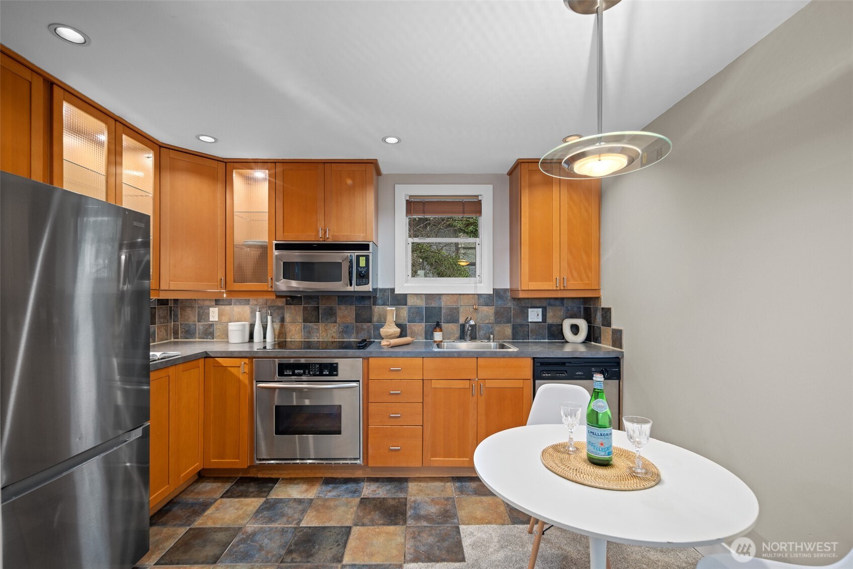 630 13th Avenue East, Unit 3 Seattle, WA 98102 - Photo 5 of 22 a kitchen with stainless steel appliances granite countertop a sink refrigerator and microwave