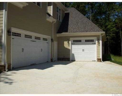 7208 Duncans Ridge Way Fuquay-Varina, NC 27526 - Photo 9 of 12 Two car side entry garage and oversized one car front entry garage provide space for storage, if needed. Parking Lot/Garage