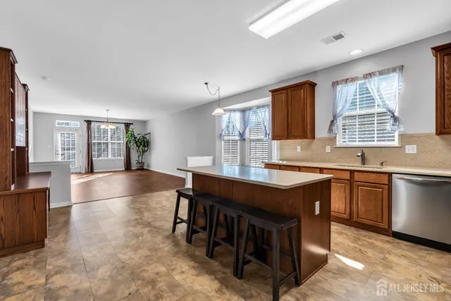 a kitchen with stainless steel appliances granite countertop a stove and a sink