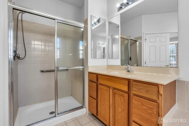 a bathroom with a shower sink and mirror