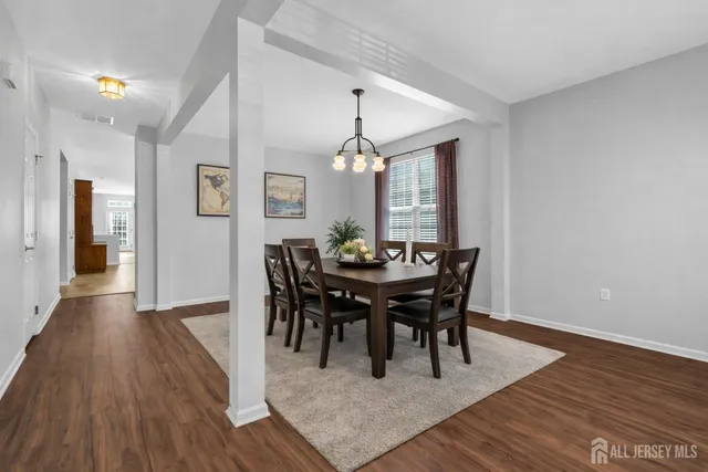a view of a a dining room with furniture window and wooden floor