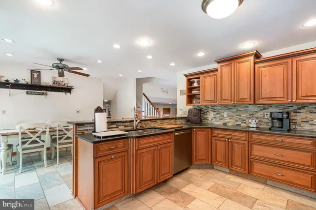 a kitchen with stainless steel appliances granite countertop a sink and cabinets