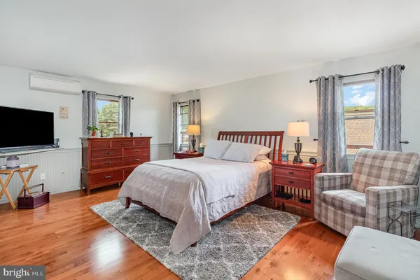 a bedroom with a bed and flat screen tv