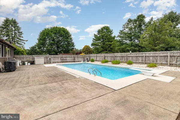 a view of a swimming pool with a lounge chair