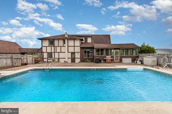 a swimming pool view with a outdoor seating