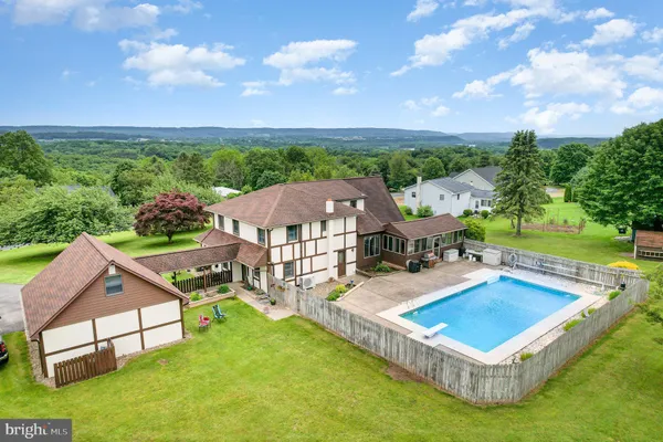 an aerial view of a house having yard patio and entertaining space