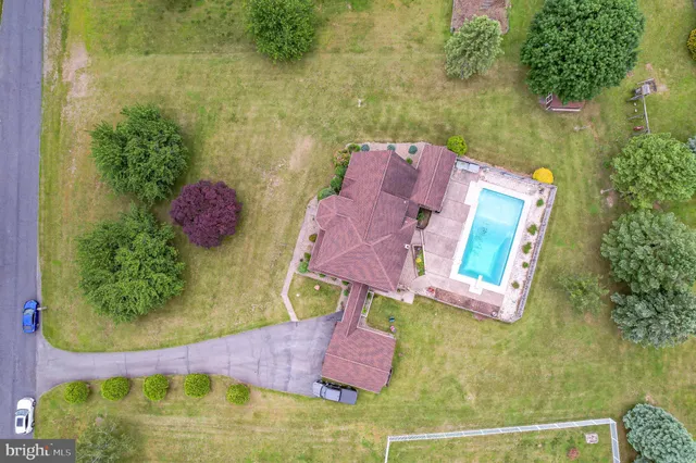 an aerial view of residential house with outdoor space and swimming pool