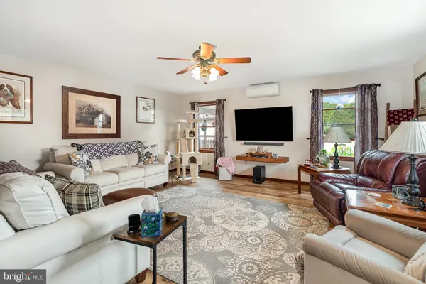 a living room with furniture and a flat screen tv