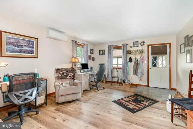 a living room with furniture a rug and a window