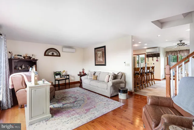 a living room with furniture or couch and a wooden floor
