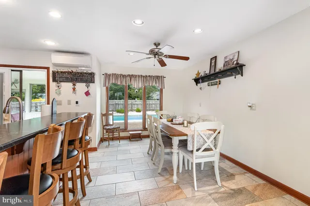 a dining room with furniture a chandelier and window