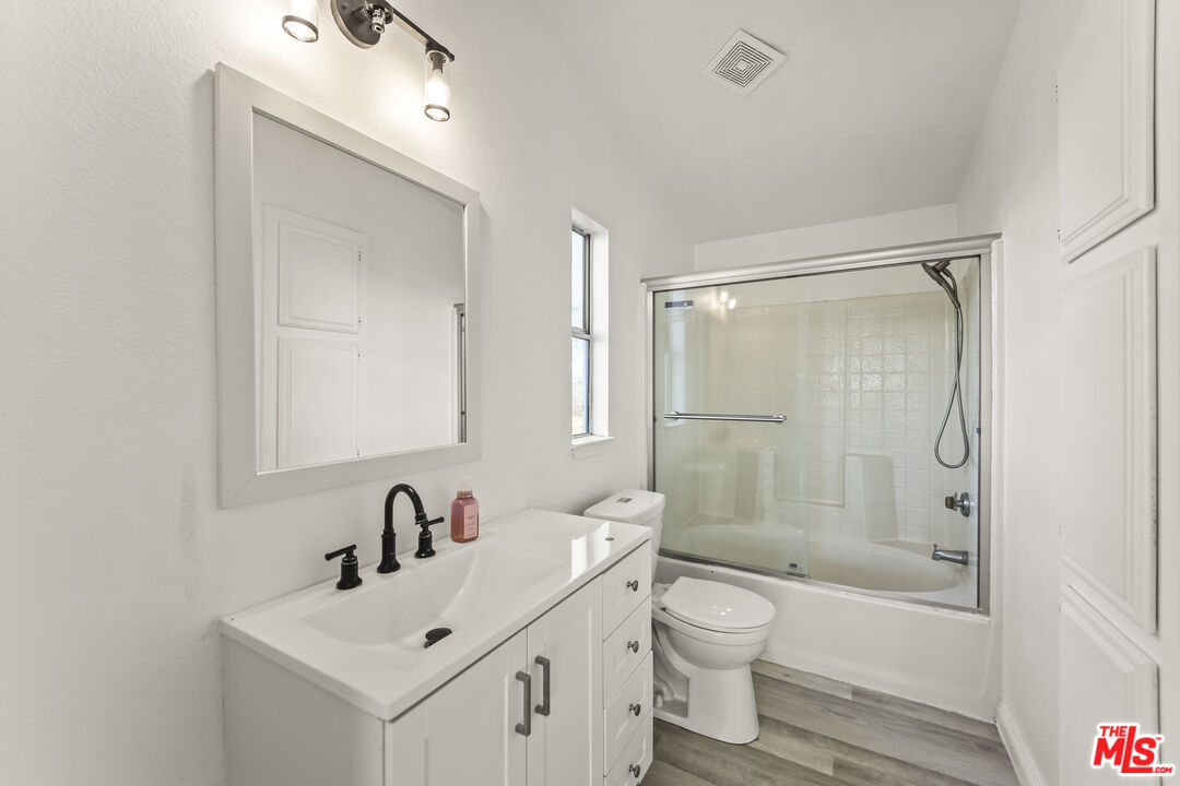 6677 Maricopa Road Phelan, CA 92371 - Photo 17 of 38 a bathroom with a bathtub shower sink mirror and toilet