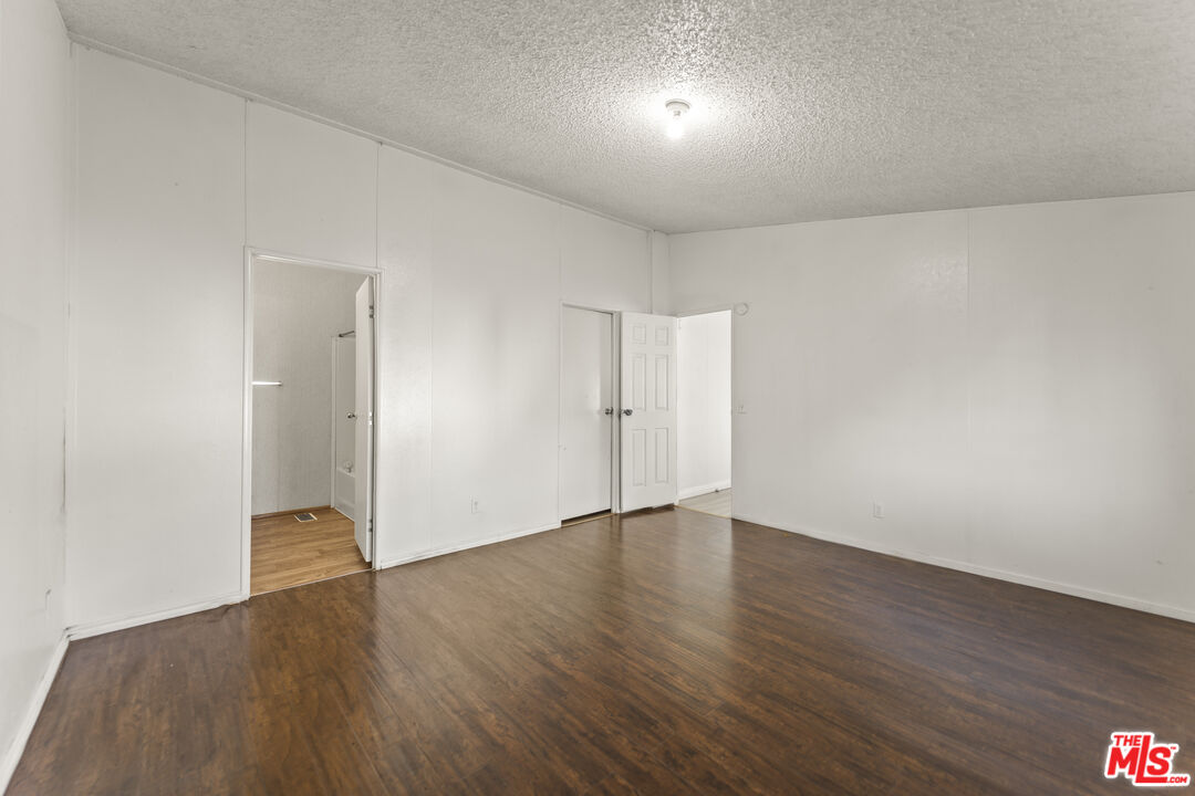 6677 Maricopa Road Phelan, CA 92371 - Photo 25 of 38 a view of an empty room with wooden floor