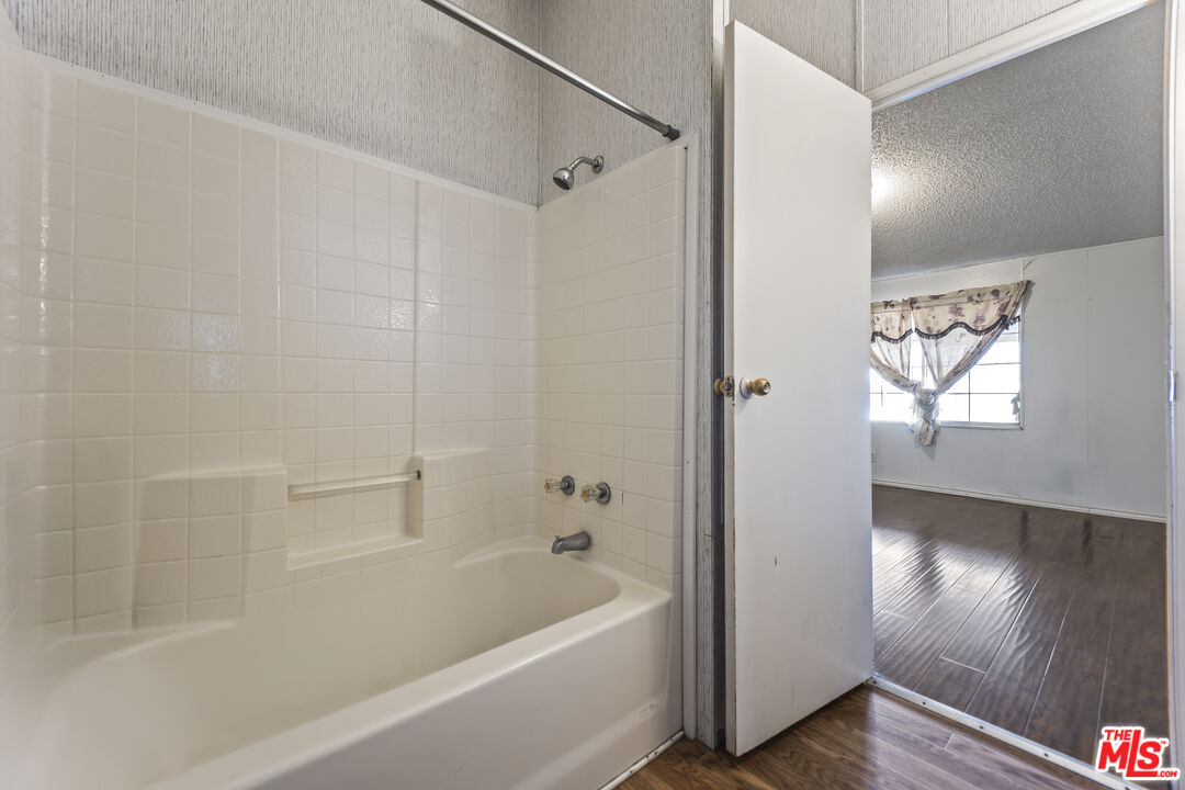 6677 Maricopa Road Phelan, CA 92371 - Photo 26 of 38 a bathroom with a bathtub and a shower