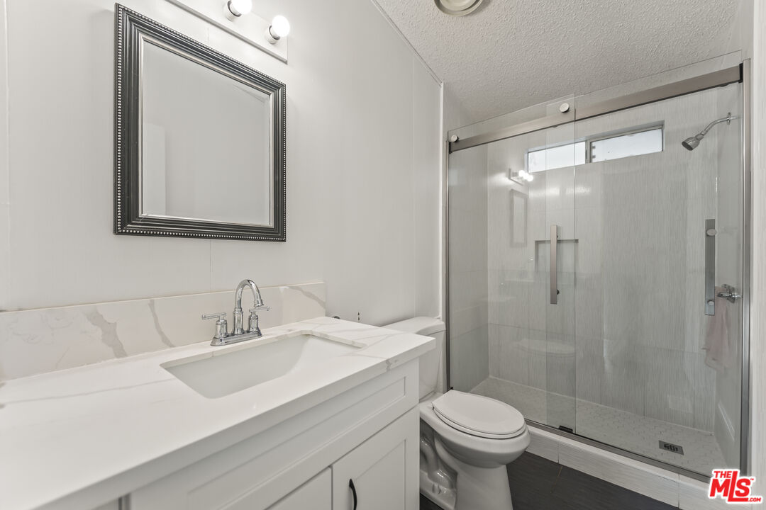6677 Maricopa Road Phelan, CA 92371 - Photo 28 of 38 a bathroom with a sink toilet and shower