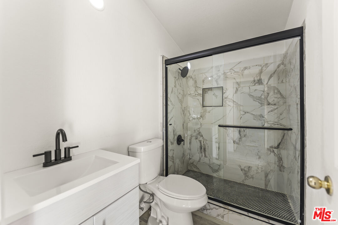 6677 Maricopa Road Phelan, CA 92371 - Photo 10 of 38 a bathroom with a shower toilet and a sink