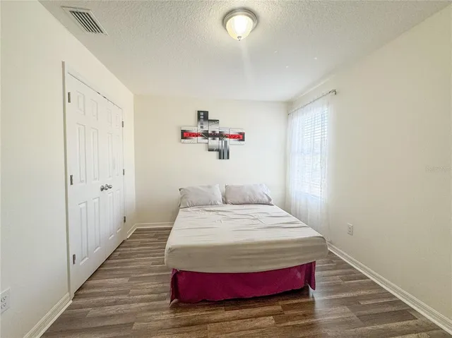 a bedroom with a bed and a window