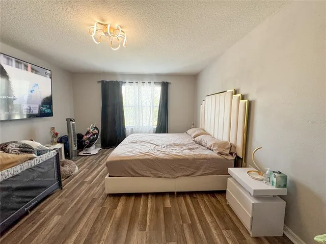 a bedroom with a bed and a chandelier