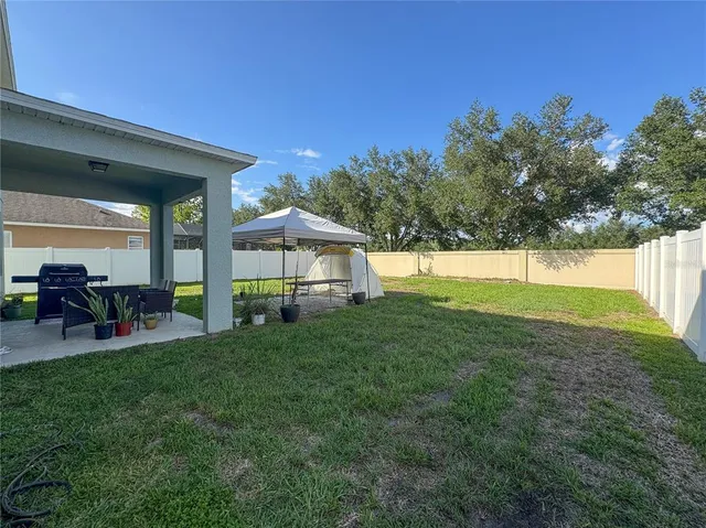 a view of an house with backyard porch and furniture