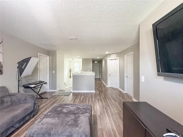 a view of a livingroom with furniture and a flat screen tv