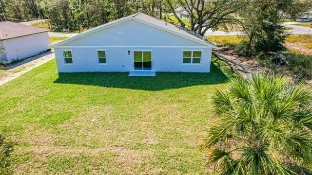 a view of backyard of house with green space