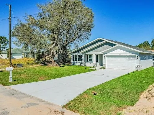a front view of house with yard and green space