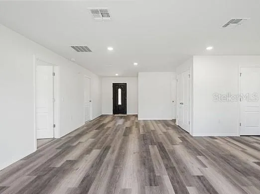 a view of an empty room and wooden floor