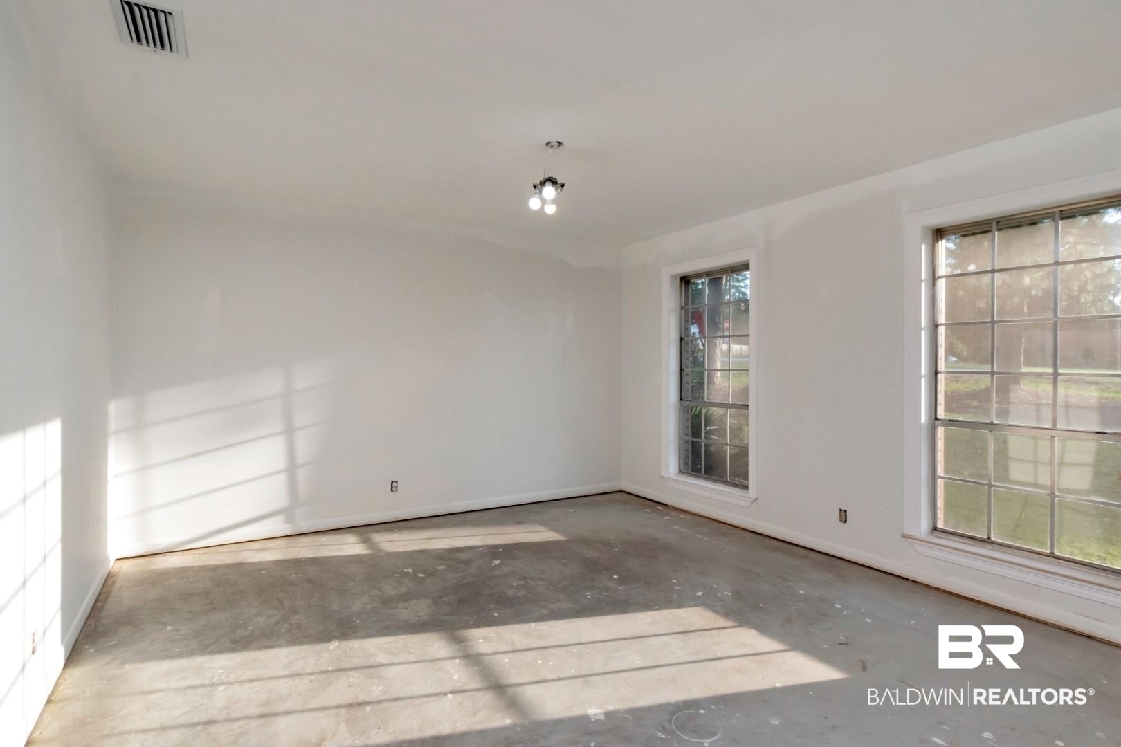 241 Suzanne Circle Mobile, AL 36608 - Photo 17 of 41 Spare room with concrete flooring and baseboards