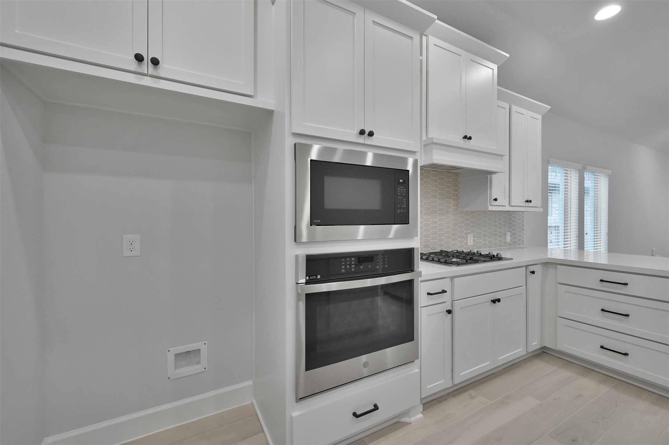 15715 Autumn Sun Conroe, TX 77302 - Photo 7 of 23 a kitchen with granite countertop white cabinets and white stainless steel appliances