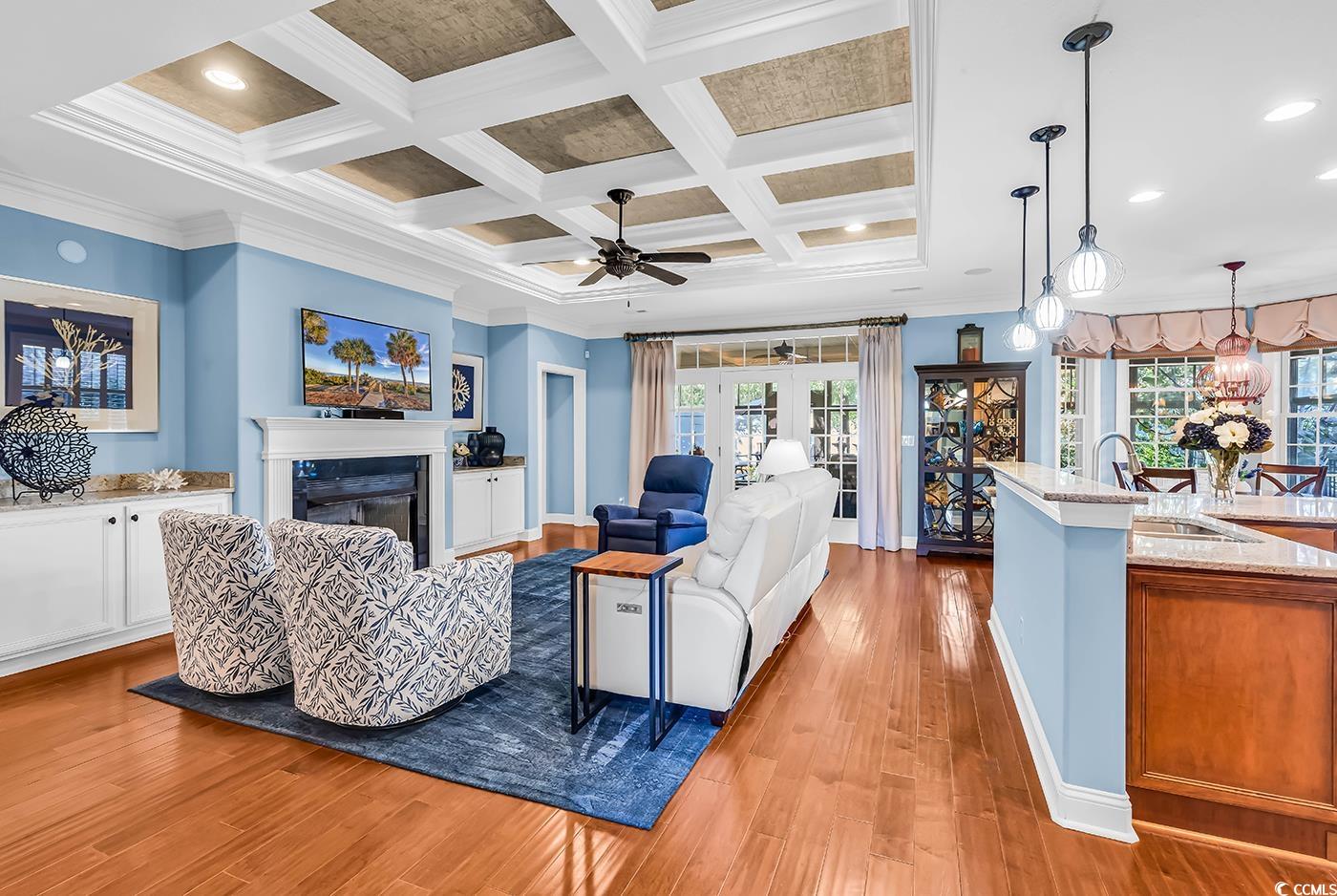 956 Corrado Street Myrtle Beach, SC 29572 - Photo 11 of 38 Living room featuring crown molding, light wood finished floors, a fireplace, beamed ceiling, and coffered ceiling