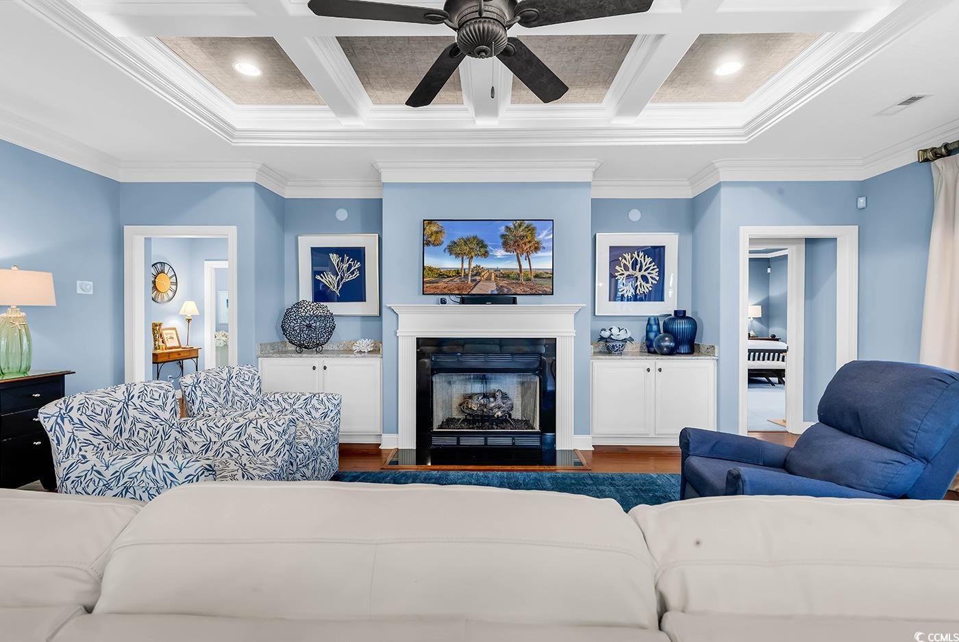 956 Corrado Street Myrtle Beach, SC 29572 - Photo 12 of 38 Living room with crown molding, a fireplace with flush hearth, wood finished floors, coffered ceiling, and beamed ceiling
