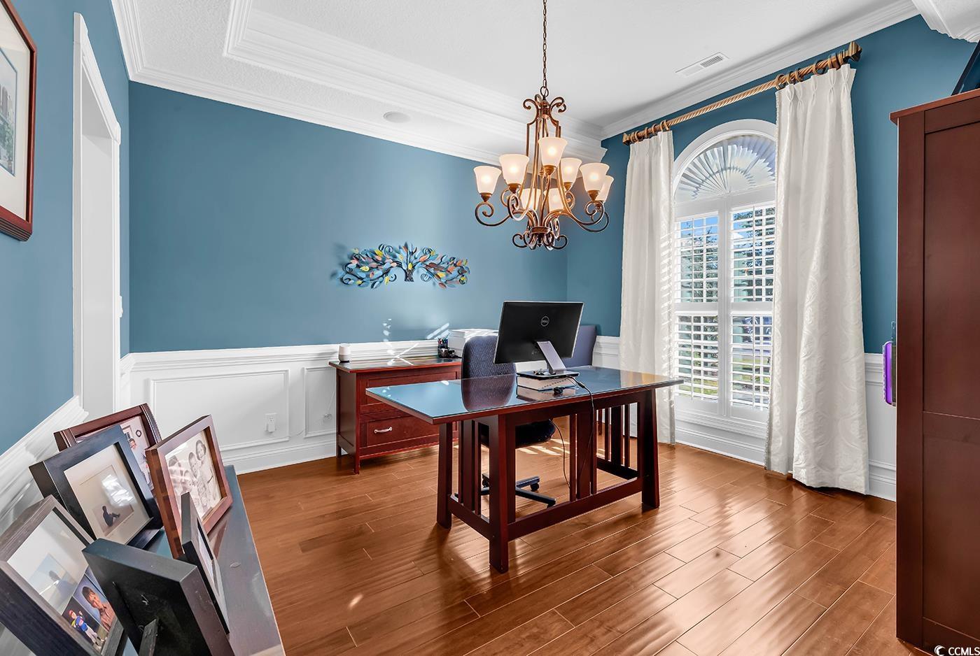 956 Corrado Street Myrtle Beach, SC 29572 - Photo 14 of 38 Office area with a wainscoted wall, ornamental molding, a decorative wall, wood finished floors, and a chandelier