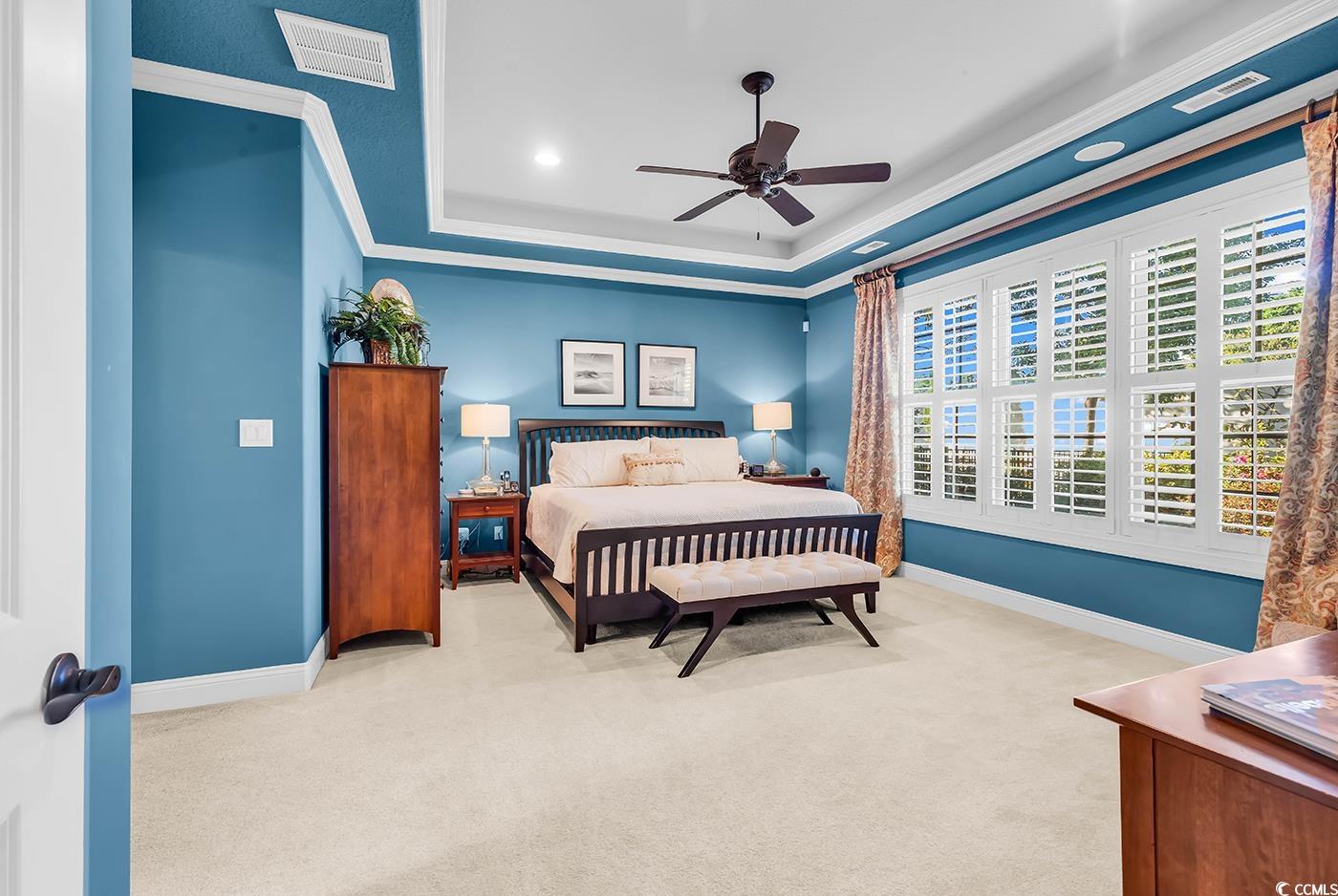 956 Corrado Street Myrtle Beach, SC 29572 - Photo 16 of 38 Bedroom featuring light colored carpet, a tray ceiling, crown molding, ceiling fan, and recessed lighting