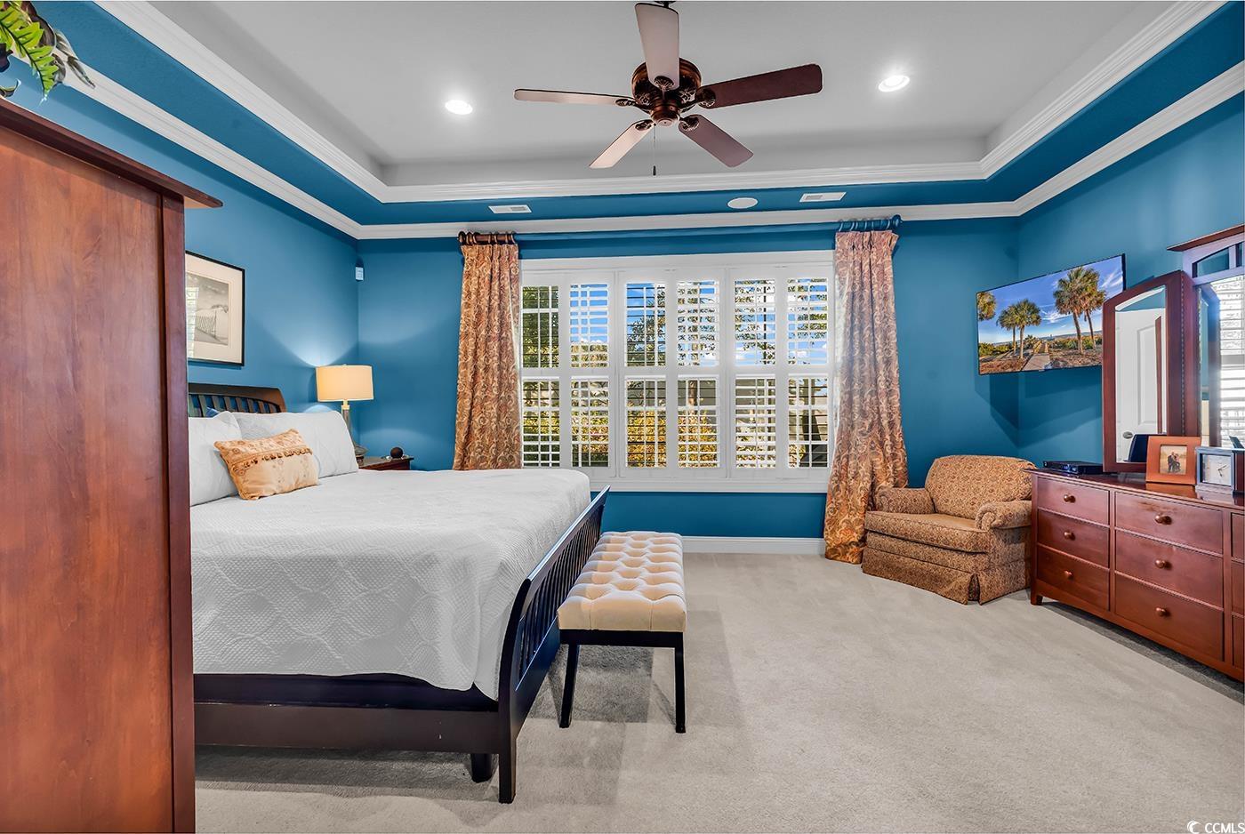 956 Corrado Street Myrtle Beach, SC 29572 - Photo 17 of 38 Bedroom featuring a tray ceiling, crown molding, a ceiling fan, and light carpet